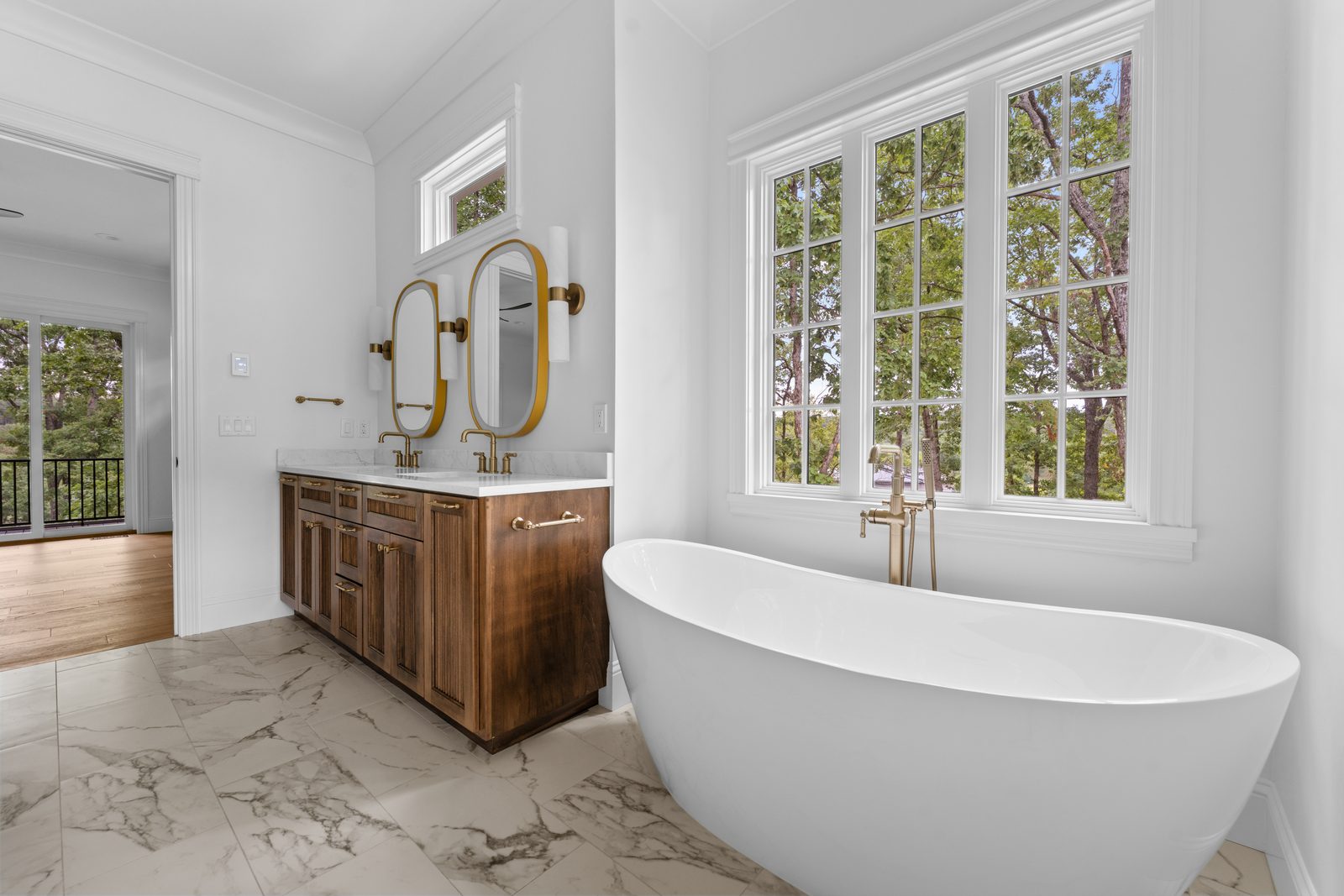 Primary bath with a freestanding tub and tiled walls
