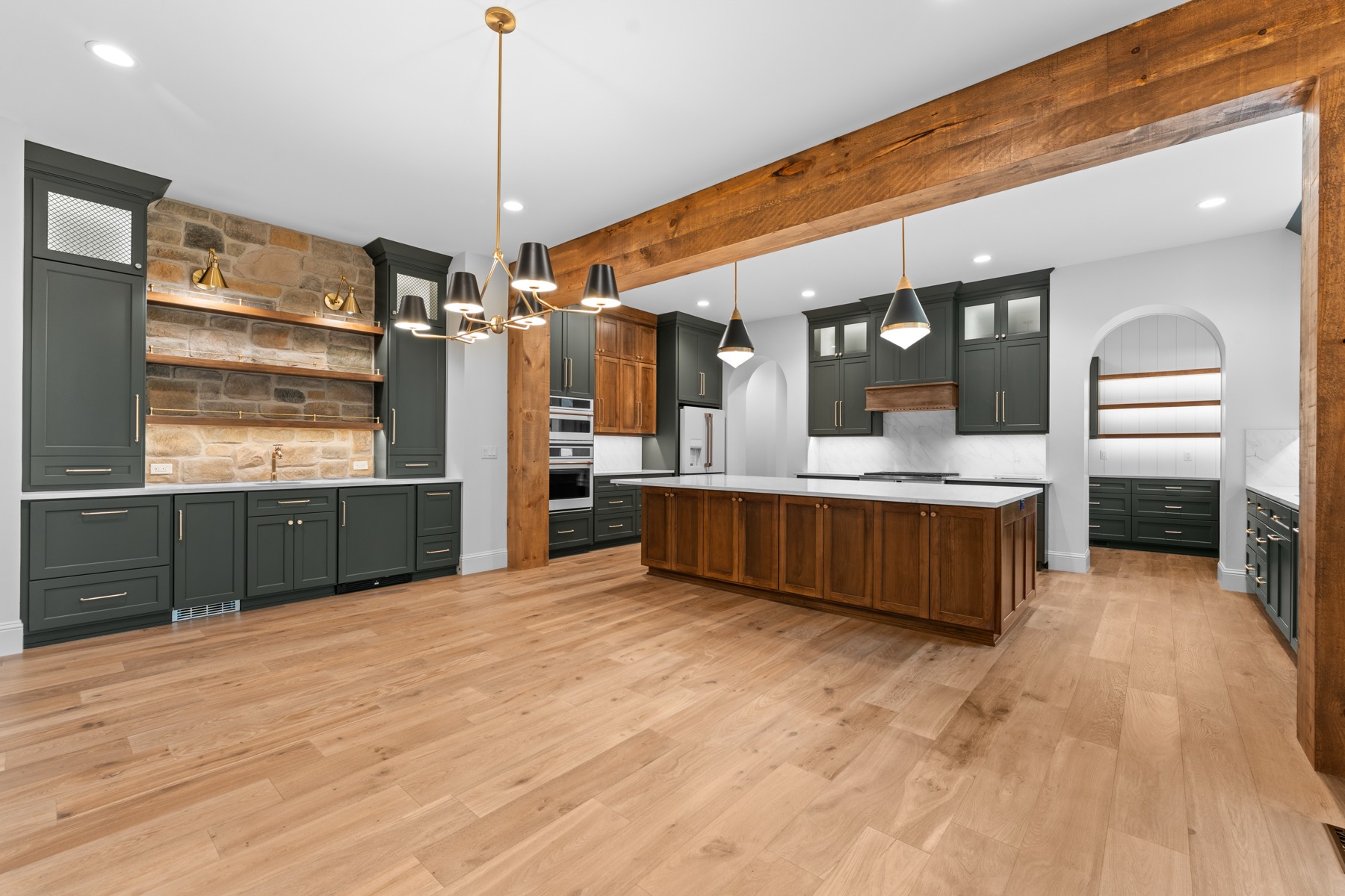 Open kitchen and great room under exposed timber beams