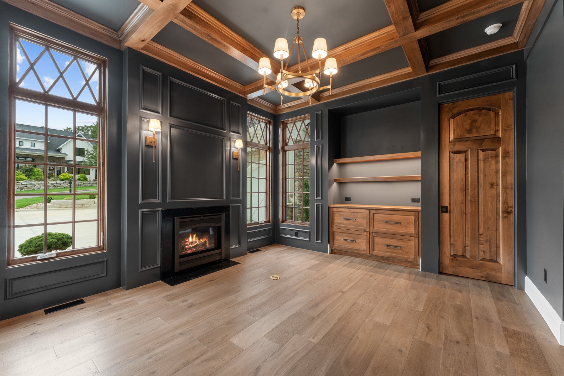 Dark paneled study with its own fireplace and built-in shelves