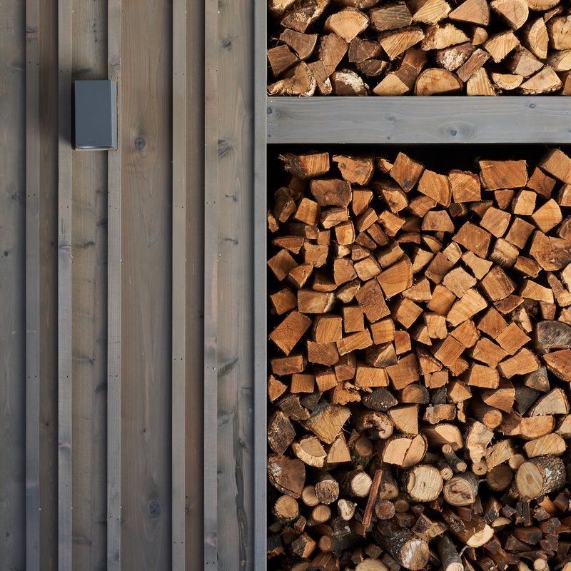 Split firewood stacked into a wall