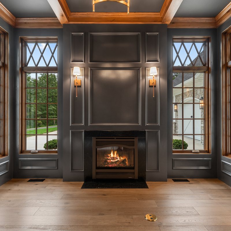 The paneled study, with leaded glass and wall sconces