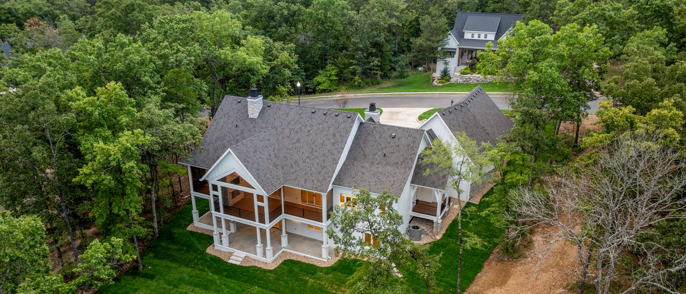 A finished home among the oaks, seen from the air