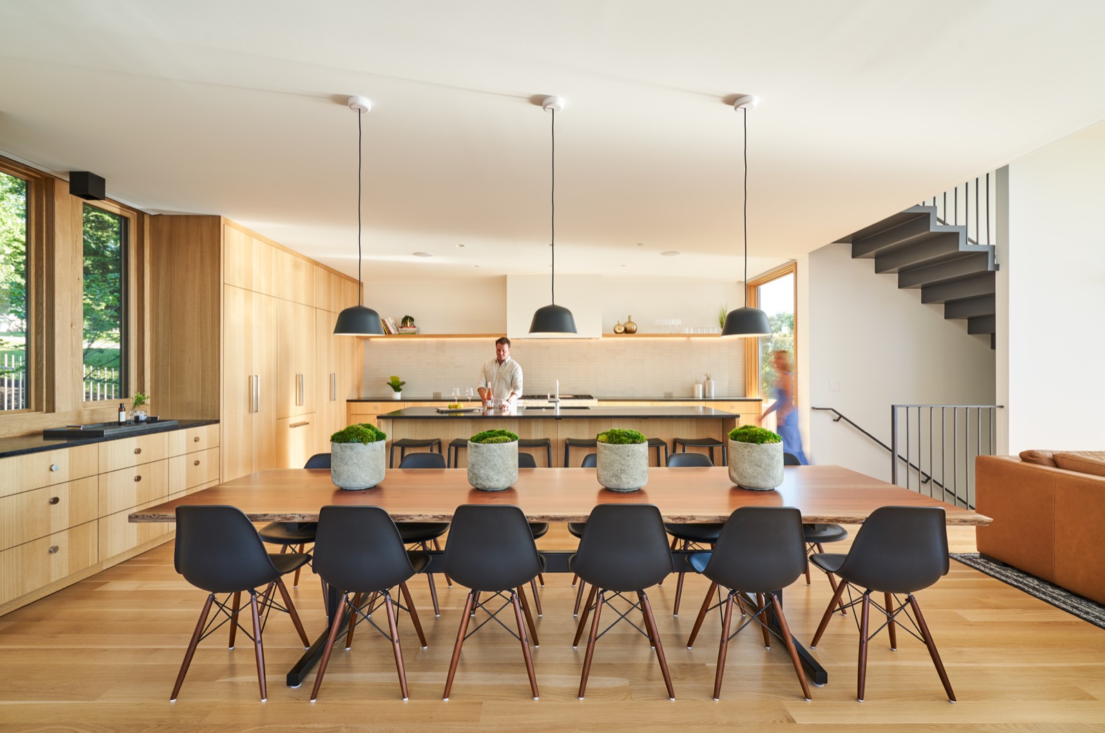 Kitchen and dining room with pendant lights over a long table