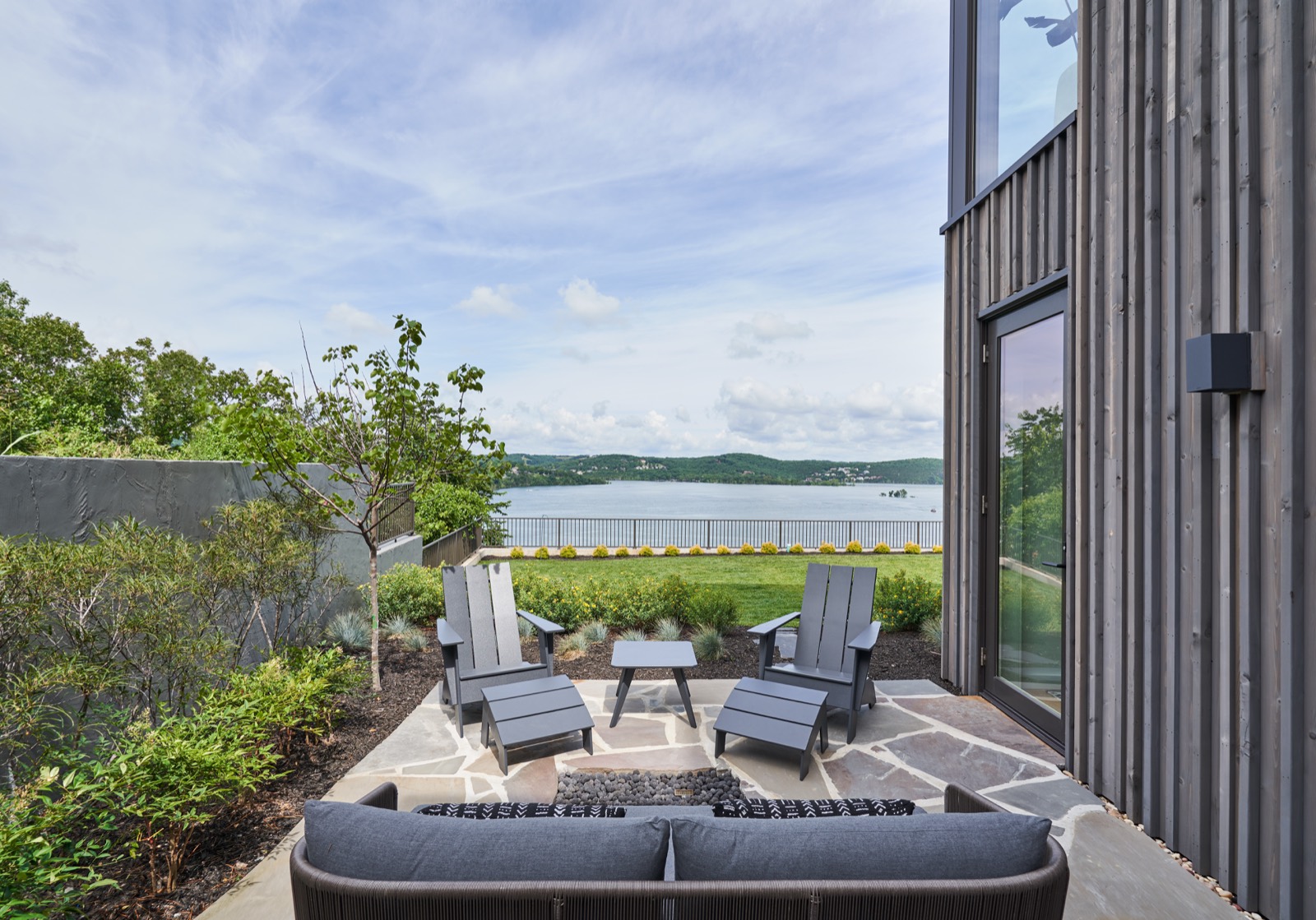 Terrace furniture with the lake and tree line beyond