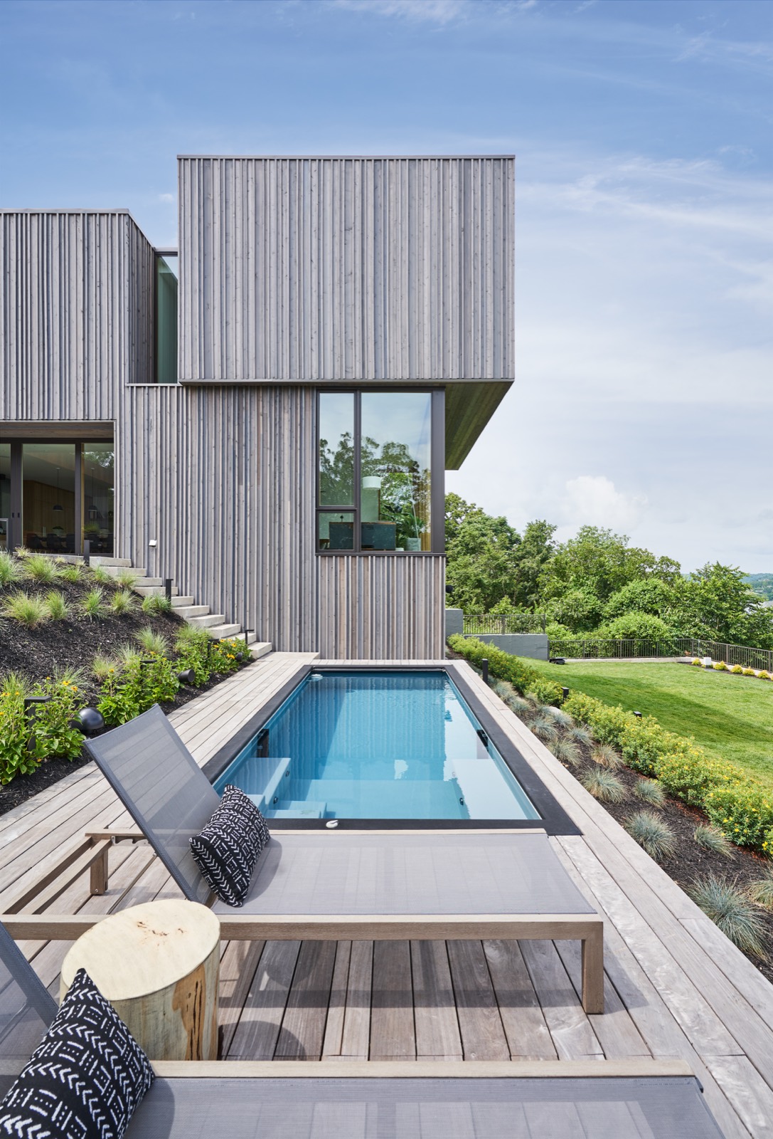 The lap pool and terrace running along the side of the house