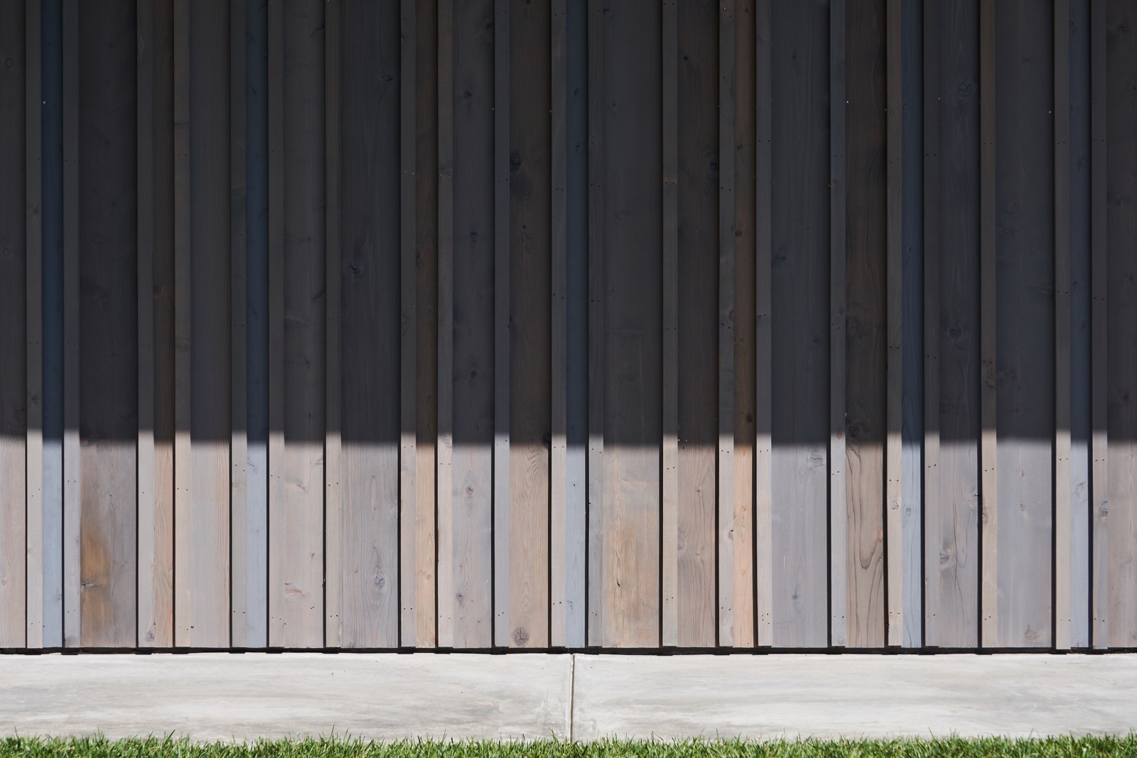 Weathered cedar boards running vertically across the facade