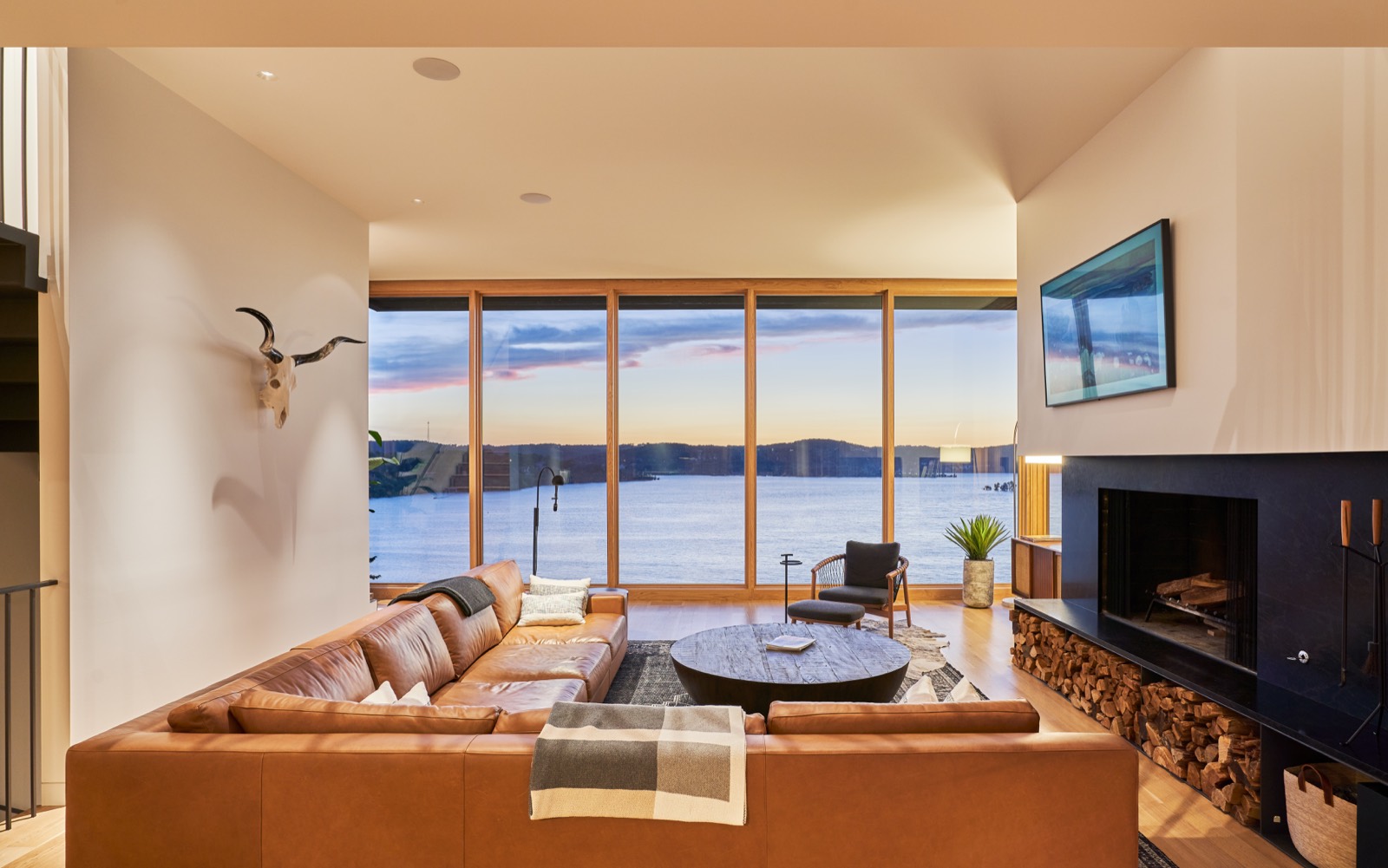 Sitting room with a round table and a stone fireplace